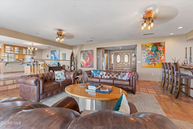 a view of a dining room with furniture and chandelier