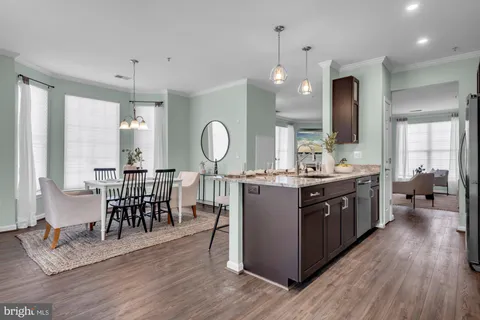 a dining room with furniture a chandelier and wooden floor