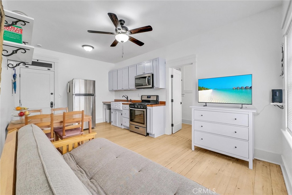 354 Chestnut Avenue, Unit 2 Long Beach, CA 90802 - Photo 1 of 25 a kitchen with stainless steel appliances kitchen island granite countertop a refrigerator and cabinets