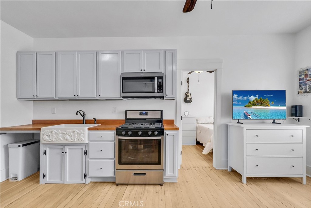 354 Chestnut Avenue, Unit 2 Long Beach, CA 90802 - Photo 3 of 25 a kitchen with stainless steel appliances a stove microwave and cabinets