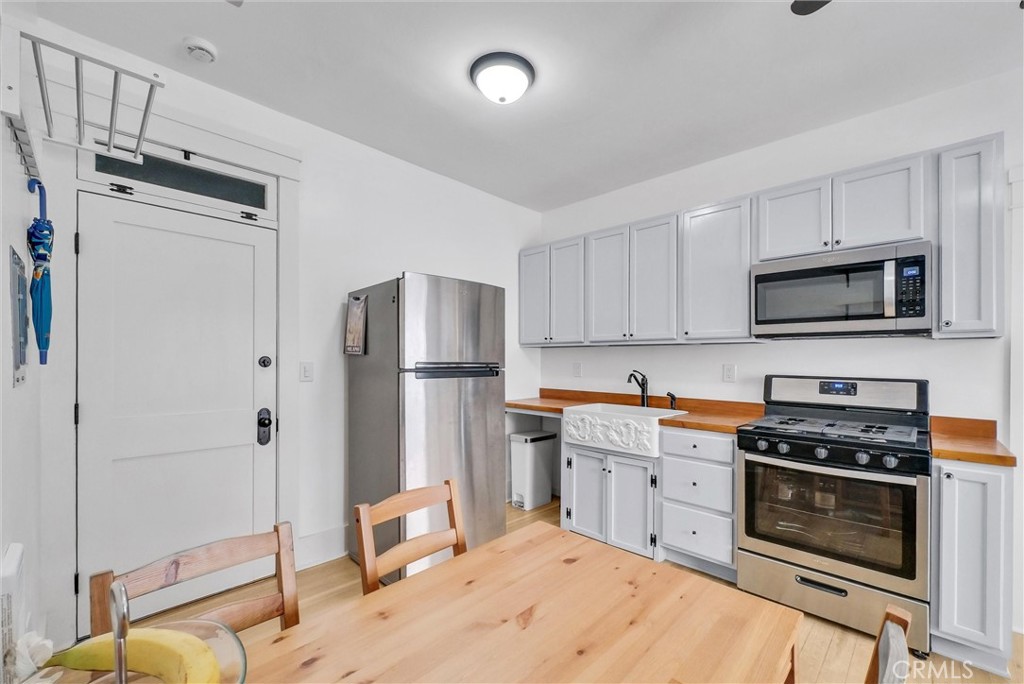 354 Chestnut Avenue, Unit 2 Long Beach, CA 90802 - Photo 7 of 25 a kitchen with stainless steel appliances a stove a refrigerator and a sink
