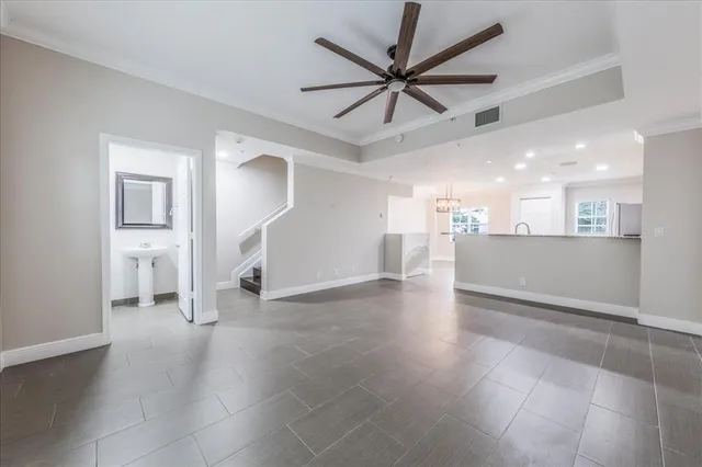 a view of a livingroom with a ceiling fan and wooden floor