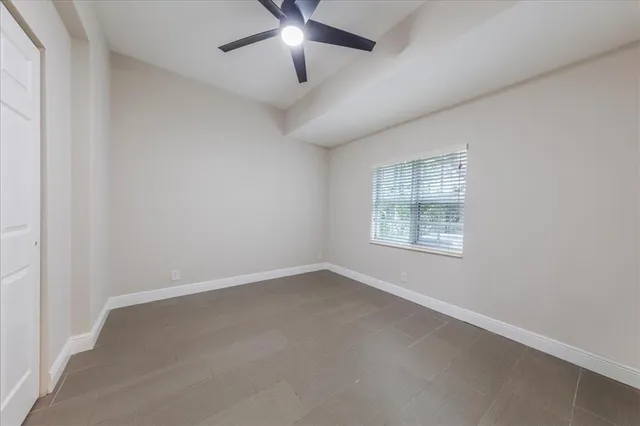an empty room with ceiling fan