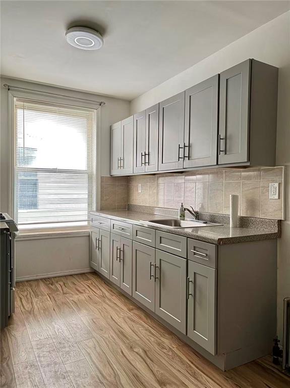 2276 78th Street Brooklyn, NY 11214 - Photo 8 of 16 a kitchen with granite countertop a sink and cabinets