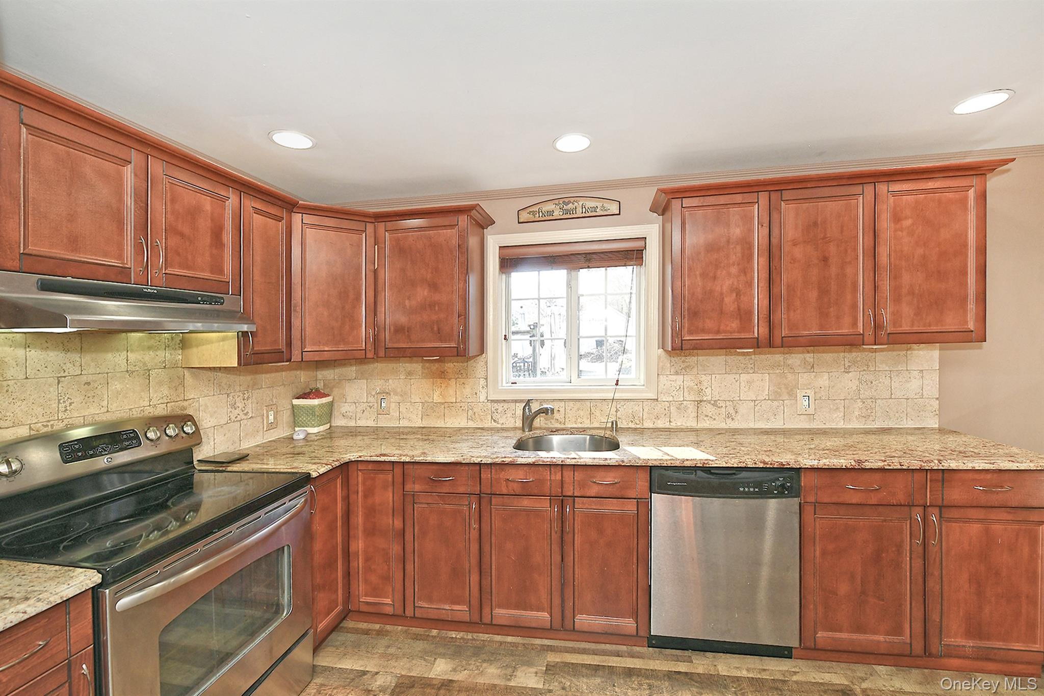 150 Hallock Landing Road Rocky Point, NY 11778 - Photo 14 of 36 Kitchen with appliances with stainless steel finishes, backsplash, light stone counters, under cabinet range hood, and recessed lighting