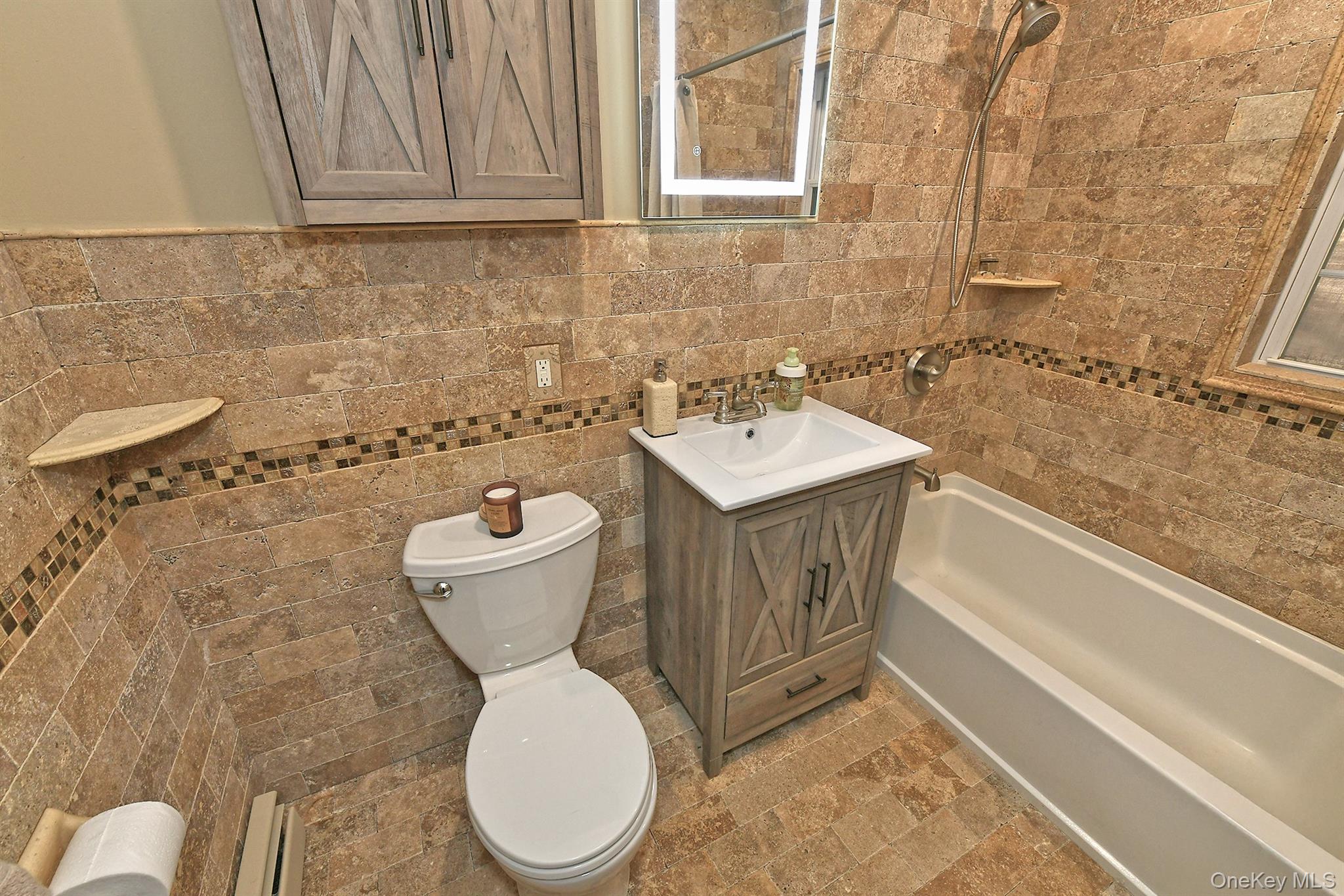 150 Hallock Landing Road Rocky Point, NY 11778 - Photo 19 of 36 Bathroom with vanity, shower combination, tile walls, and a baseboard heating unit