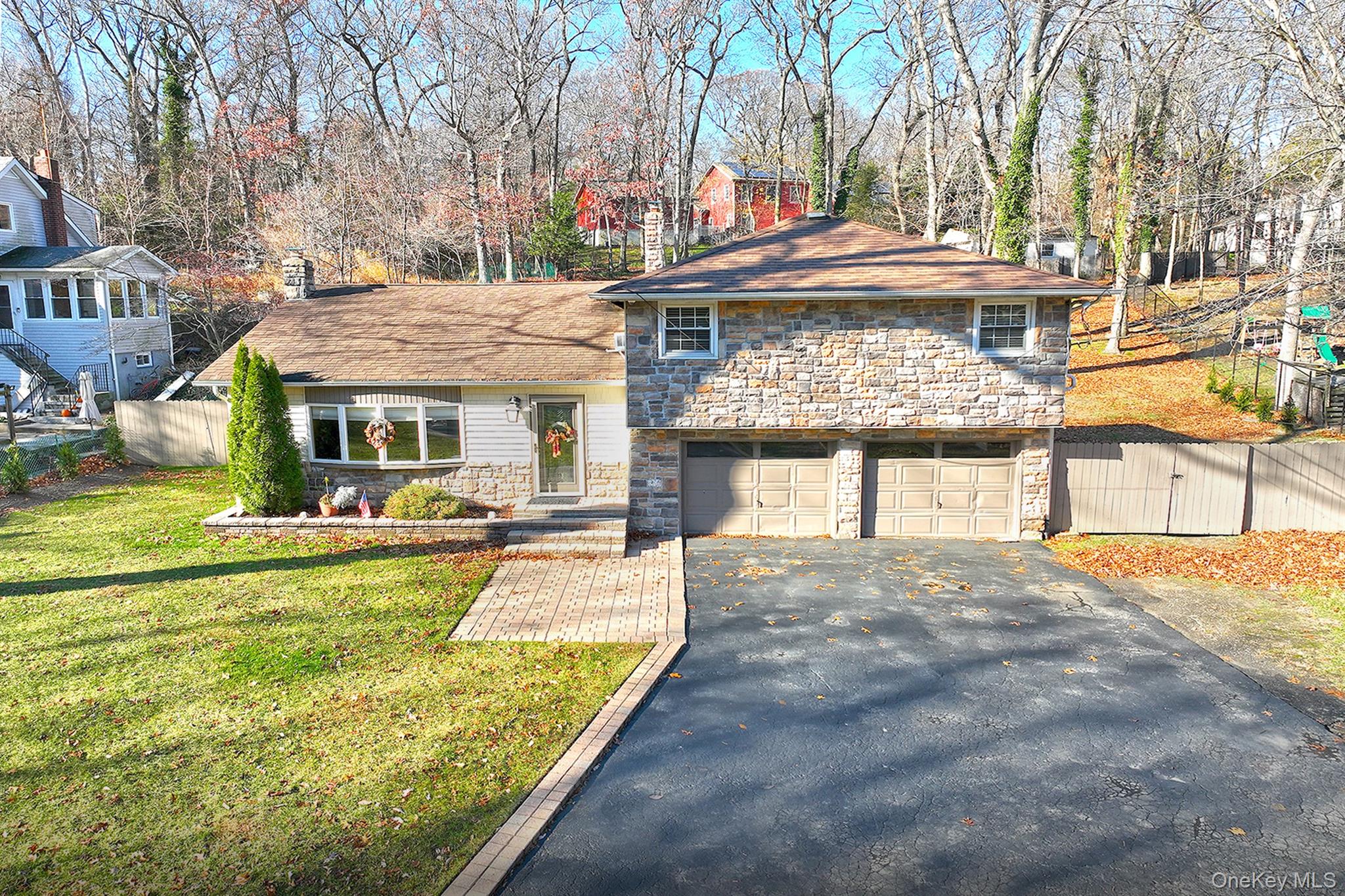 150 Hallock Landing Road Rocky Point, NY 11778 - Photo 2 of 36 Tri-level home with stone siding, driveway, and a garage