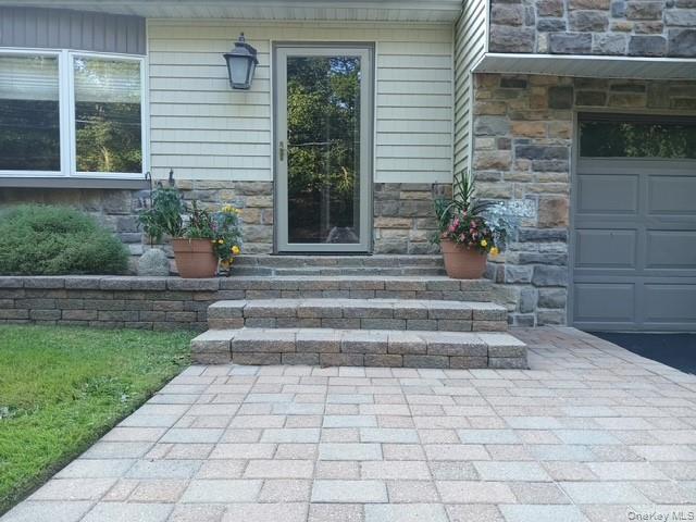 150 Hallock Landing Road Rocky Point, NY 11778 - Photo 6 of 36 Property entrance featuring stone siding and a garage