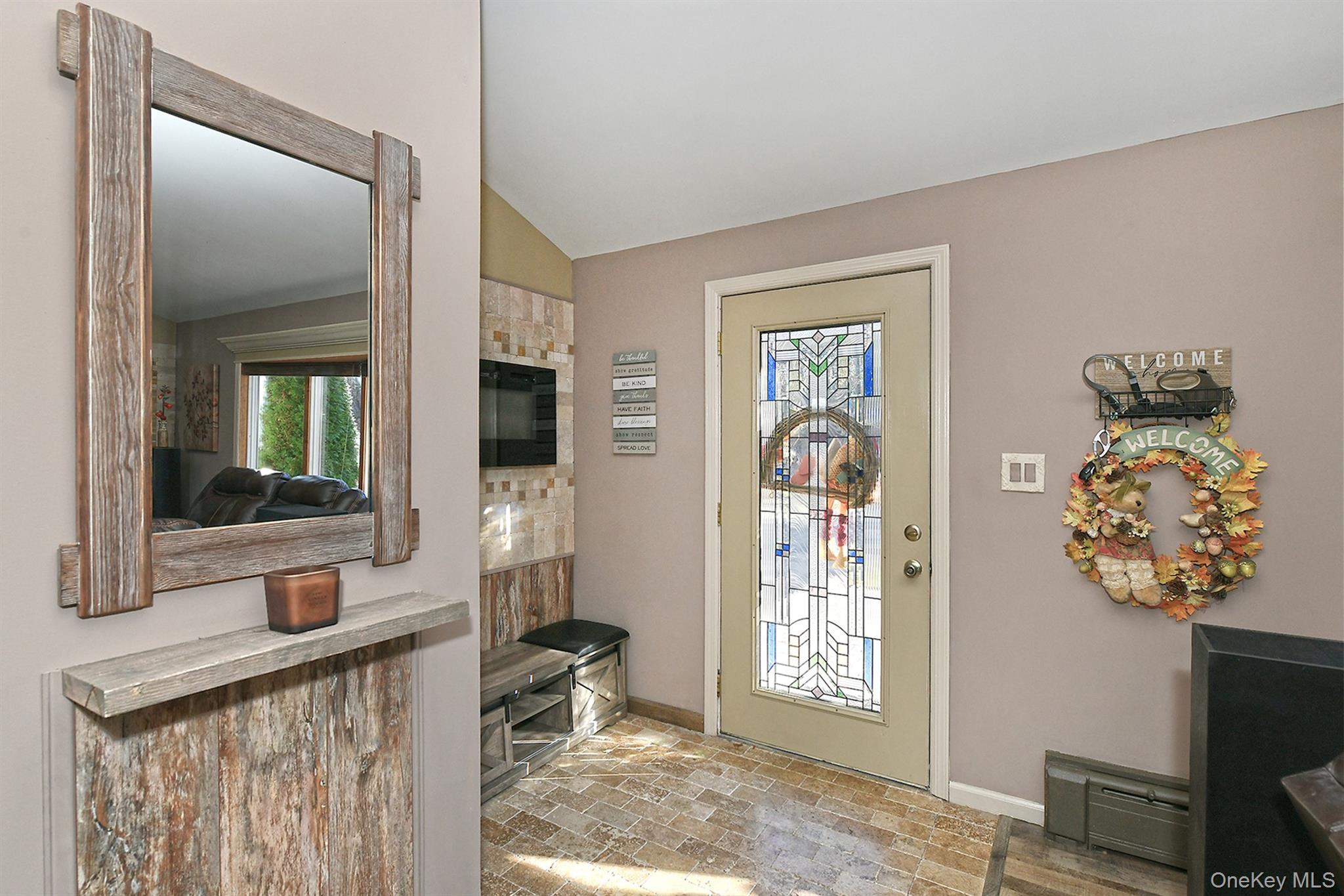 150 Hallock Landing Road Rocky Point, NY 11778 - Photo 7 of 36 Entryway with baseboard heating, brick flooring, healthy amount of natural light, and lofted ceiling