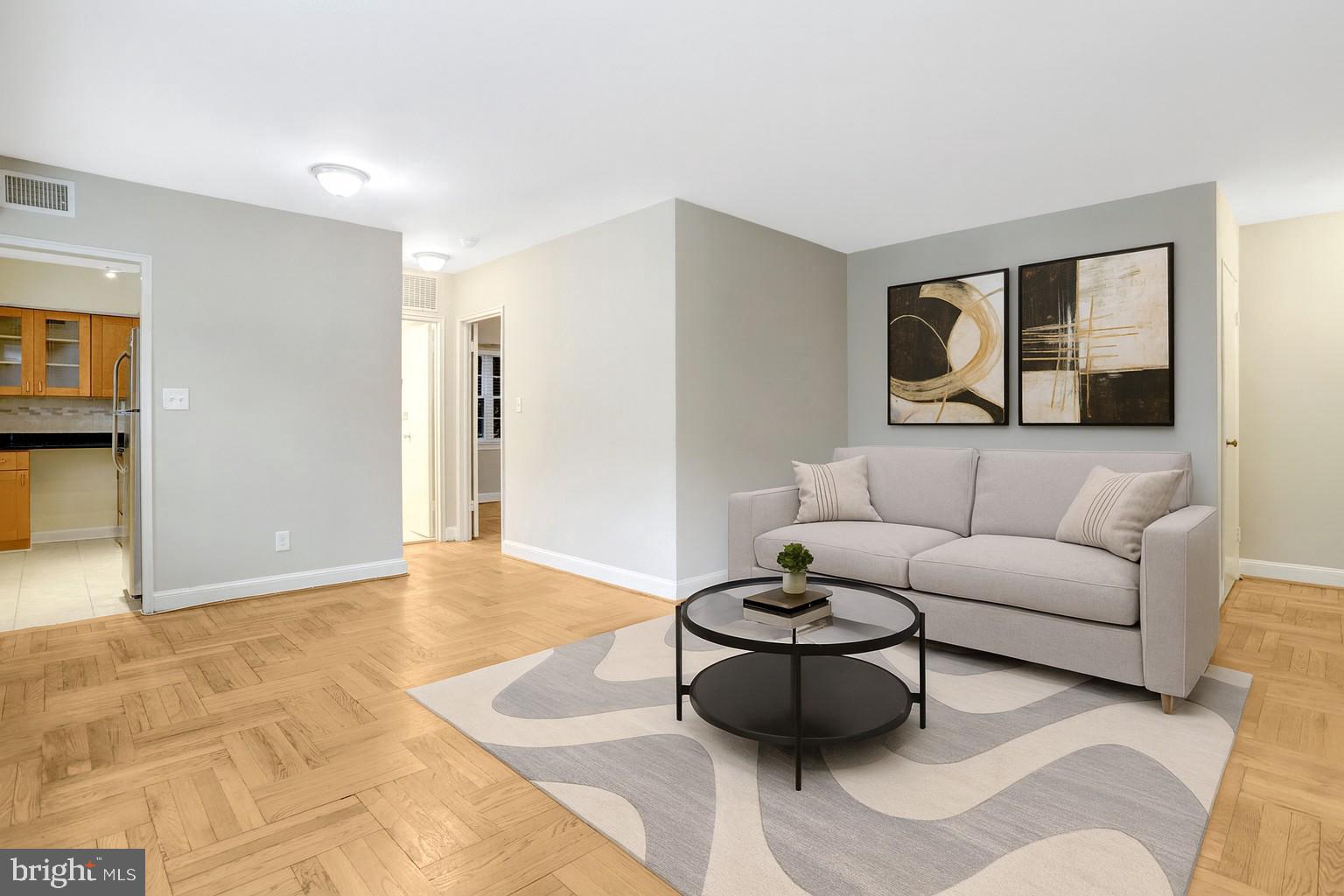 1307 North Ode Street, Unit 424 Arlington, VA 22209 - Photo 2 of 14 a living room with furniture and painting on the wall