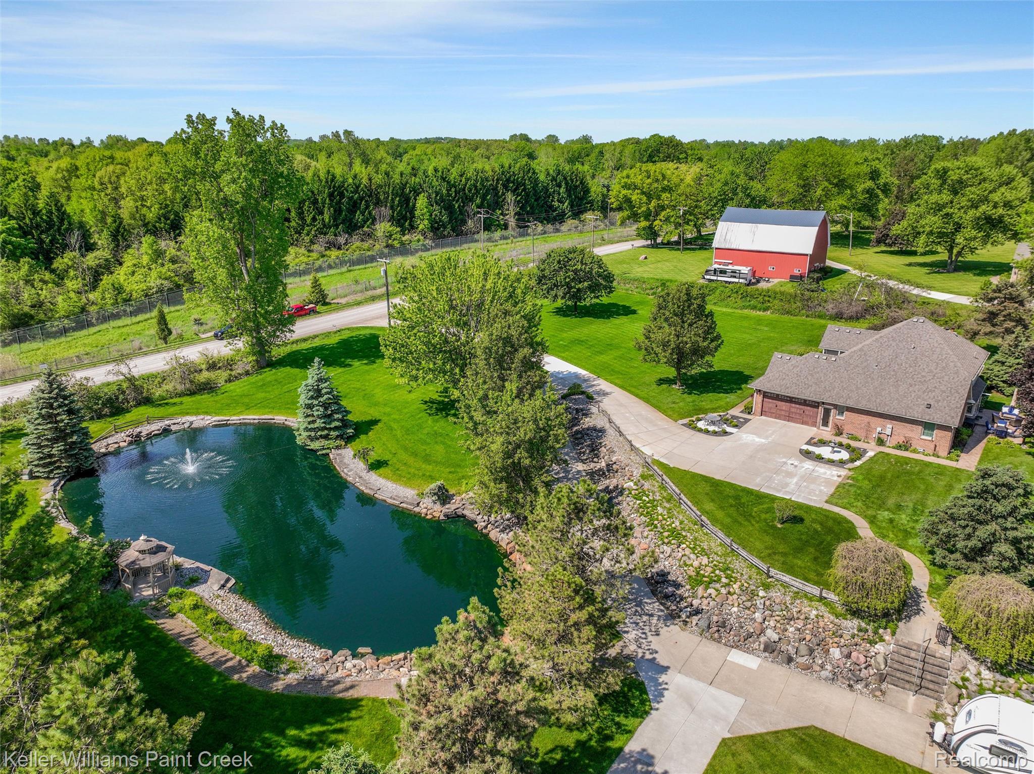 5813 36 Mile Road Romeo, MI 48065 - Photo 69 of 81 Spacious property featuring a large pond with a fountain, a dedicated gazebo, and extensive green landscaping