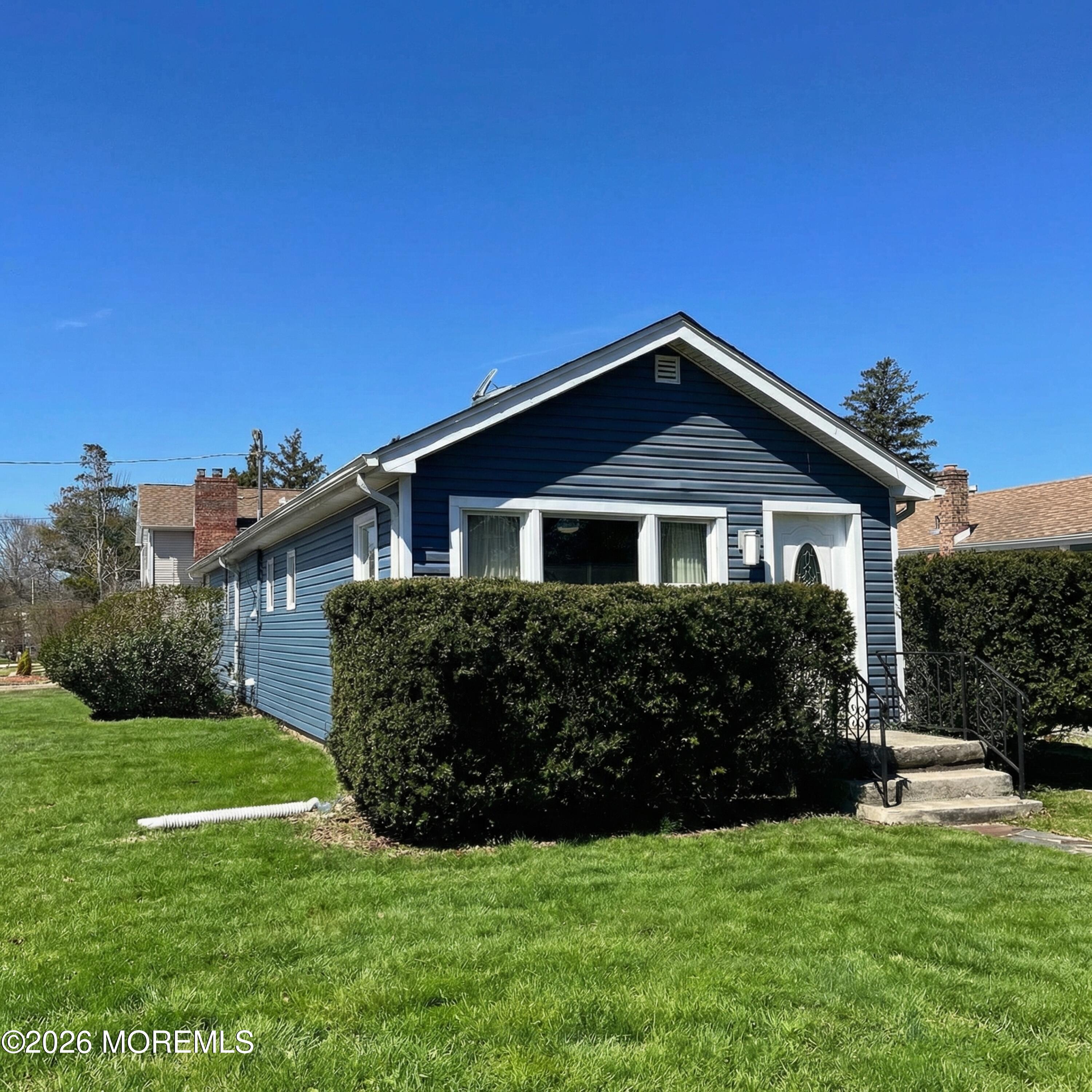 a front view of a house with a garden