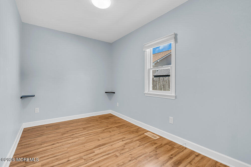 1407 Edgemere Road Wall, NJ 07719 - Photo 15 of 17 a view of empty room with wooden floor