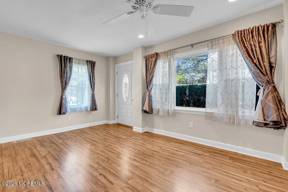1407 Edgemere Road Wall, NJ 07719 - Photo 6 of 17 a view of an empty room with wooden floor and a window