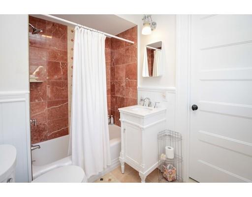 929 Beacon Street Newton, MA 02459 - Photo 18 of 36 a bathroom with a sink a mirror and a shower