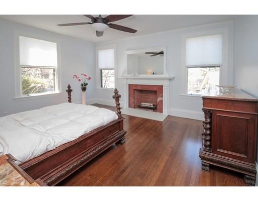 929 Beacon Street Newton, MA 02459 - Photo 20 of 36 a bedroom with a bed and a fireplace