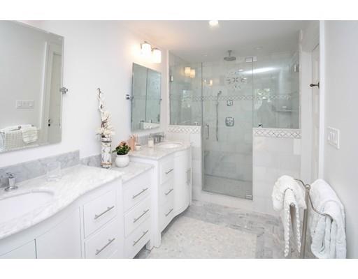 929 Beacon Street Newton, MA 02459 - Photo 22 of 36 a bathroom with a double vanity sink mirror and shower