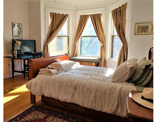 929 Beacon Street Newton, MA 02459 - Photo 24 of 36 a bedroom with a bed and a flat tv screen on dresser