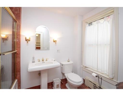929 Beacon Street Newton, MA 02459 - Photo 25 of 36 a bathroom with a toilet sink a mirror and vanity