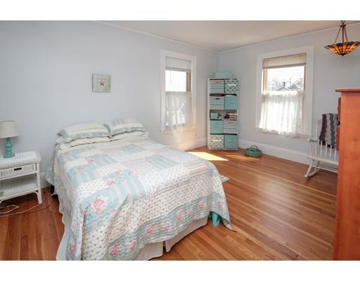 929 Beacon Street Newton, MA 02459 - Photo 33 of 36 a spacious bedroom with a bed and a table in it