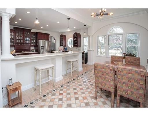 929 Beacon Street Newton, MA 02459 - Photo 10 of 36 a open kitchen with granite countertop a stove a sink and a dining table