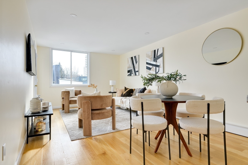 321 Harvard Street, Unit 307 Cambridge, MA 02139 - Photo 1 of 26 a living room with furniture and a large window