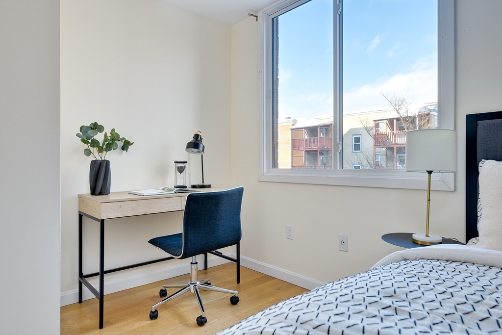 321 Harvard Street, Unit 307 Cambridge, MA 02139 - Photo 15 of 26 a workspace with furniture and window
