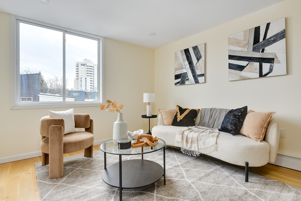 321 Harvard Street, Unit 307 Cambridge, MA 02139 - Photo 2 of 26 a living room with furniture and a large window