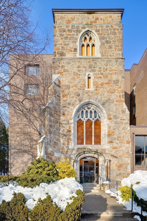 321 Harvard Street, Unit 307 Cambridge, MA 02139 - Photo 26 of 26 a front view of a building with parking space