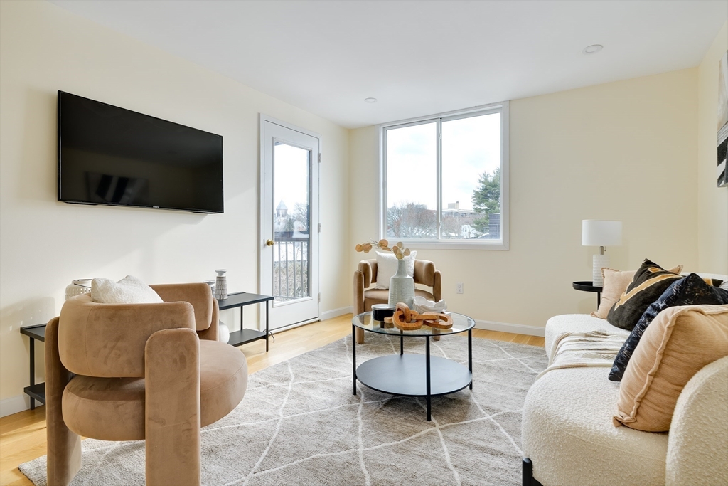 321 Harvard Street, Unit 307 Cambridge, MA 02139 - Photo 3 of 26 a living room with furniture and a flat screen tv