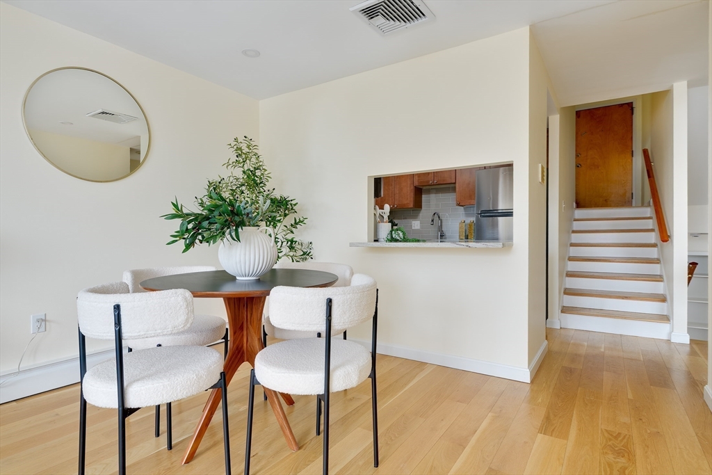321 Harvard Street, Unit 307 Cambridge, MA 02139 - Photo 4 of 26 a view of a dining room with furniture and wooden floor