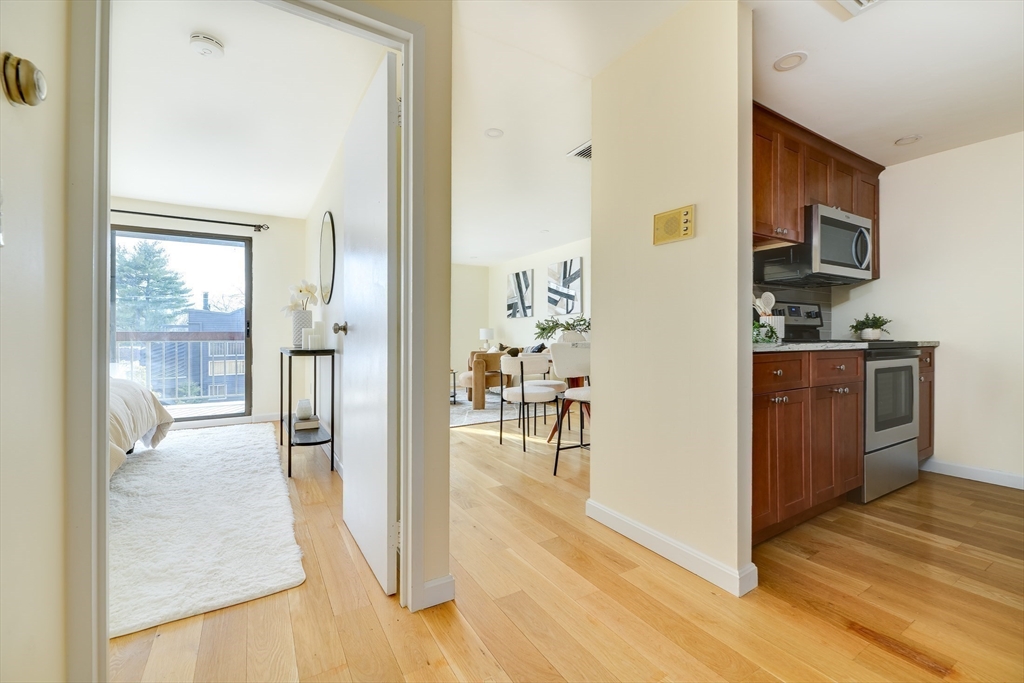 321 Harvard Street, Unit 307 Cambridge, MA 02139 - Photo 5 of 26 a view of a kitchen from the hallway