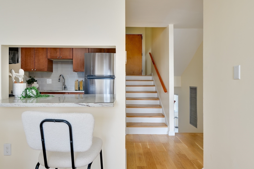 321 Harvard Street, Unit 307 Cambridge, MA 02139 - Photo 6 of 26 a kitchen with stainless steel appliances granite countertop a refrigerator and a stove
