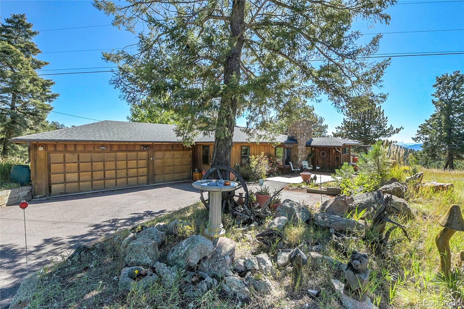 13082 South Wamblee Valley Road Conifer, CO 80433 - Photo 12 of 46 a front view of a house with garden