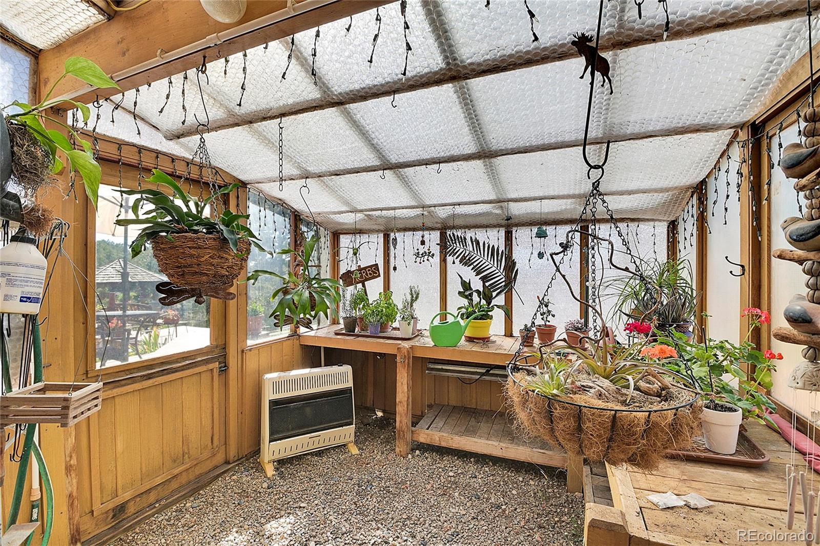 13082 South Wamblee Valley Road Conifer, CO 80433 - Photo 16 of 46 a room with furniture and a potted plant