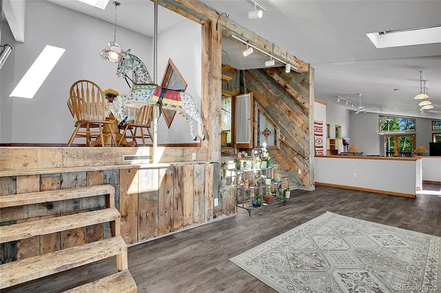a view of a room with wooden floor and windows