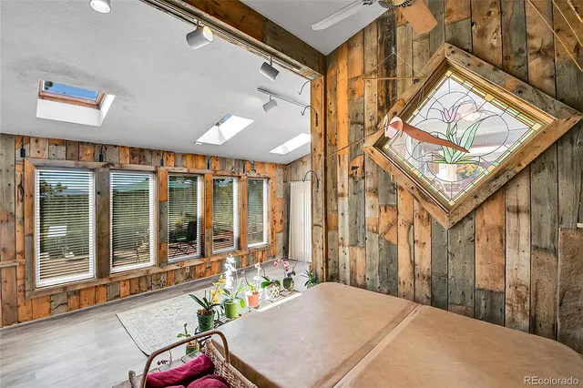 a view of a big room with wooden floor and windows