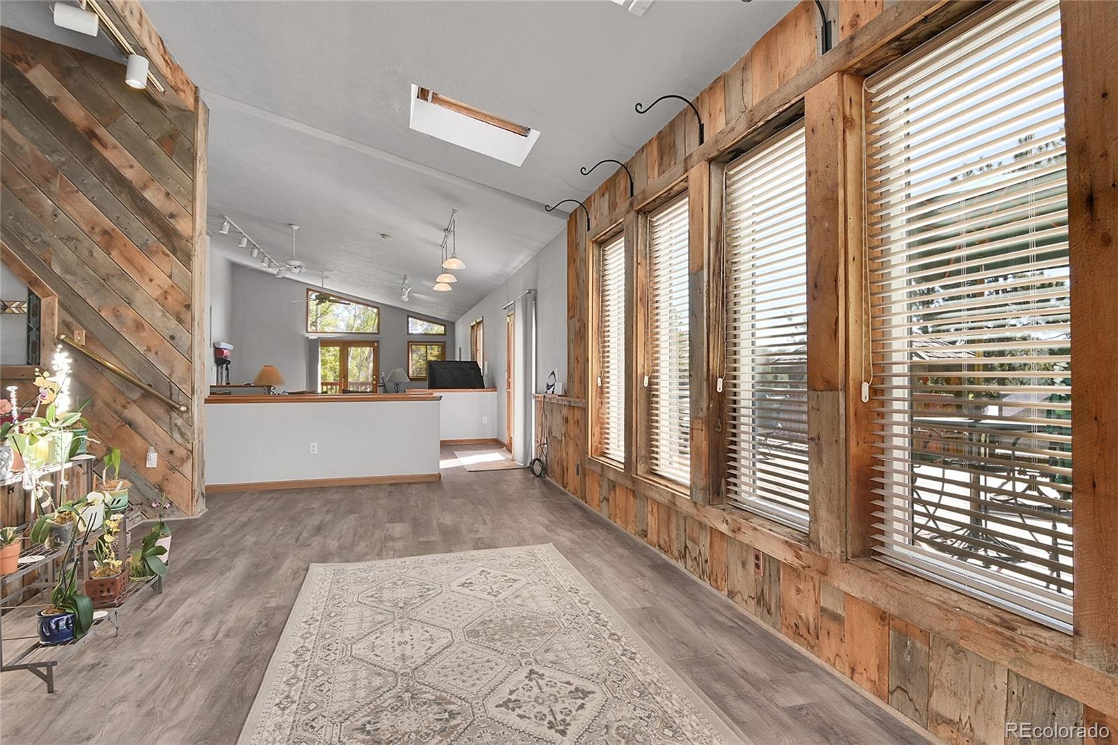 13082 South Wamblee Valley Road Conifer, CO 80433 - Photo 27 of 46 a view of a big room with wooden floor and windows