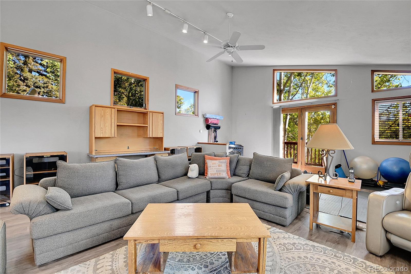 13082 South Wamblee Valley Road Conifer, CO 80433 - Photo 33 of 46 a living room with furniture a flat screen tv and a window