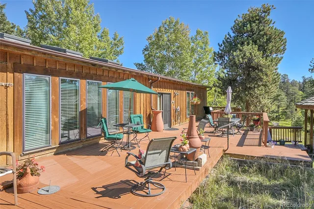 a view of a patio with table and chairs and floor to ceiling window