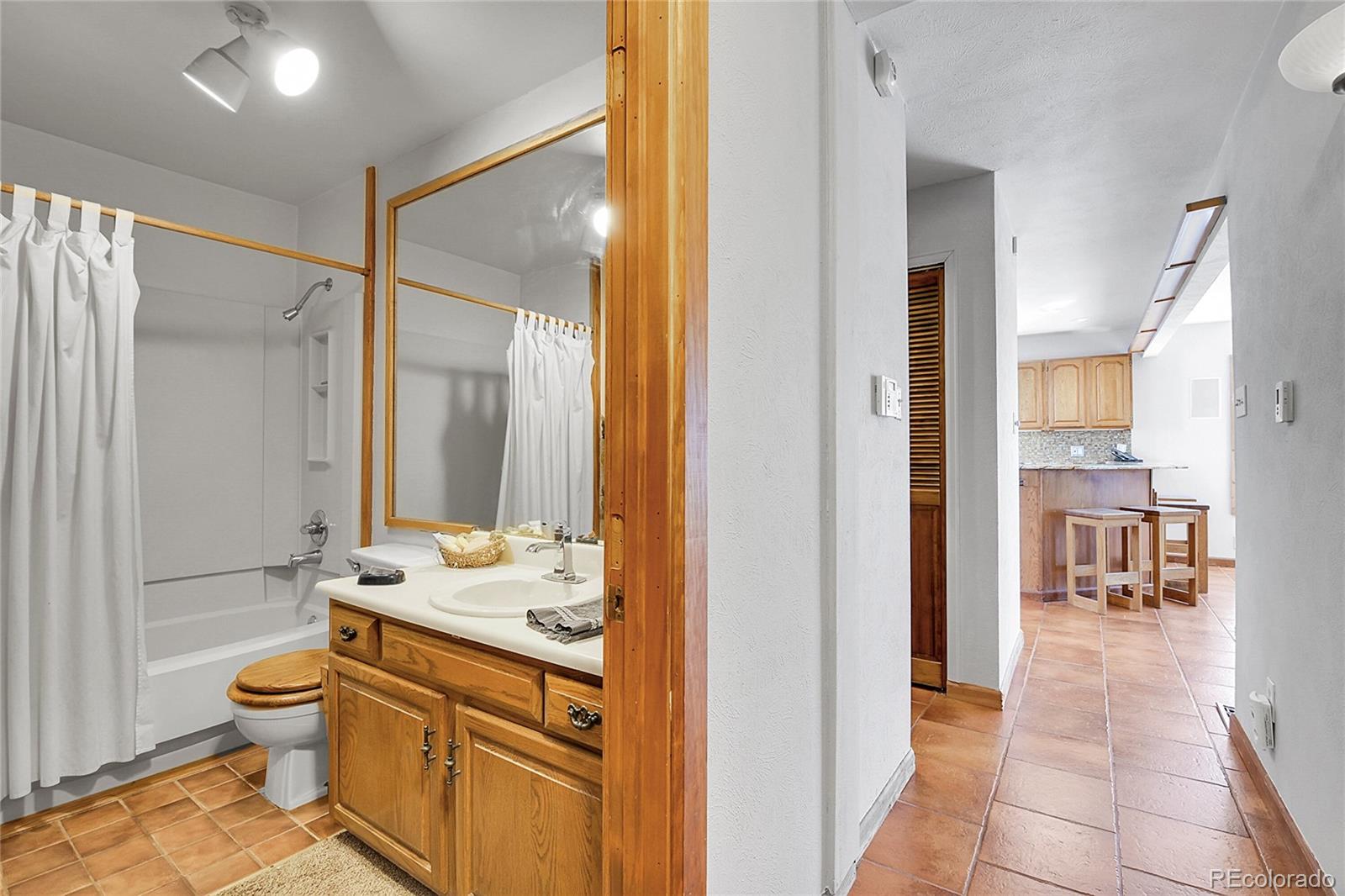13082 South Wamblee Valley Road Conifer, CO 80433 - Photo 44 of 46 a bathroom with a granite countertop sink toilet and shower