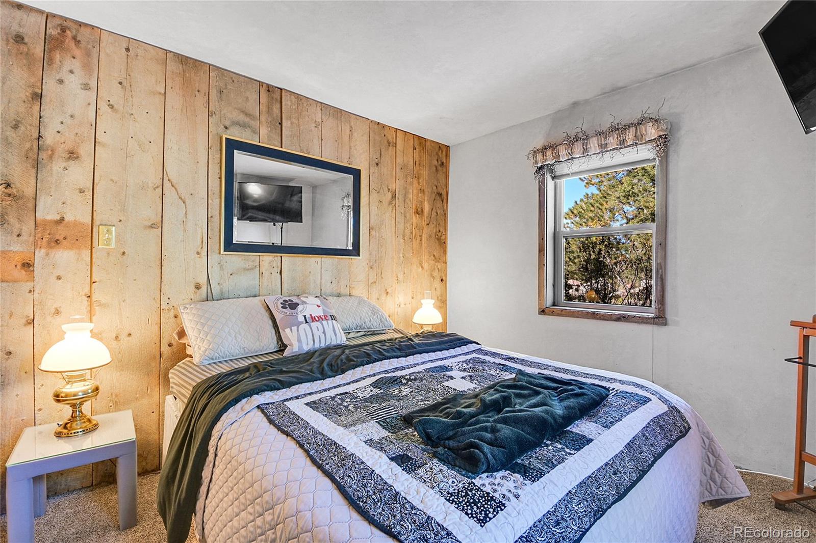 13082 South Wamblee Valley Road Conifer, CO 80433 - Photo 46 of 46 a bed sitting in a bedroom next to a window