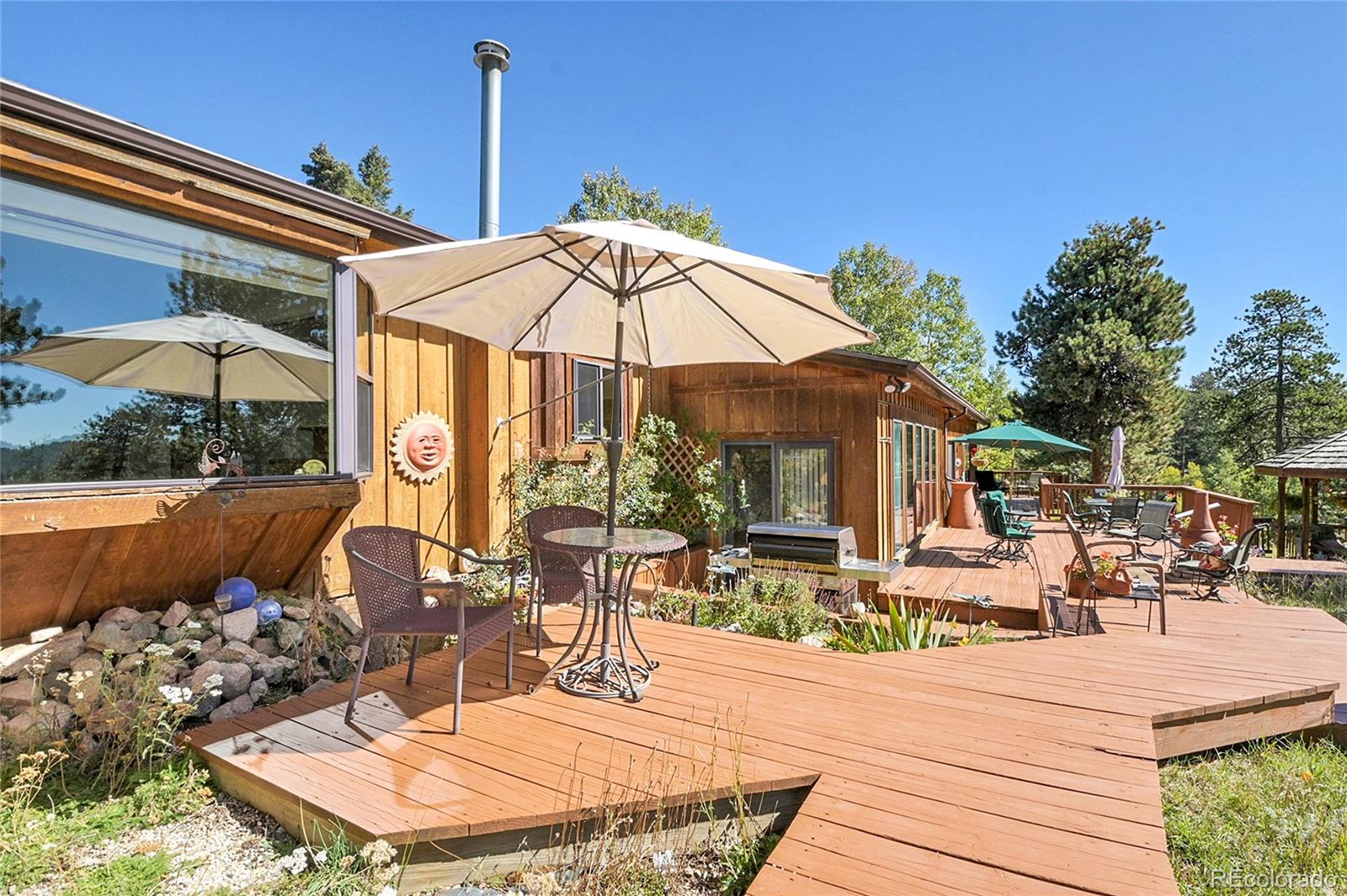 13082 South Wamblee Valley Road Conifer, CO 80433 - Photo 6 of 46 a view of a patio with swimming pool table and chairs