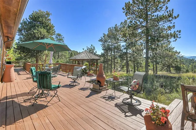 a view of a balcony with chairs and wooden floor