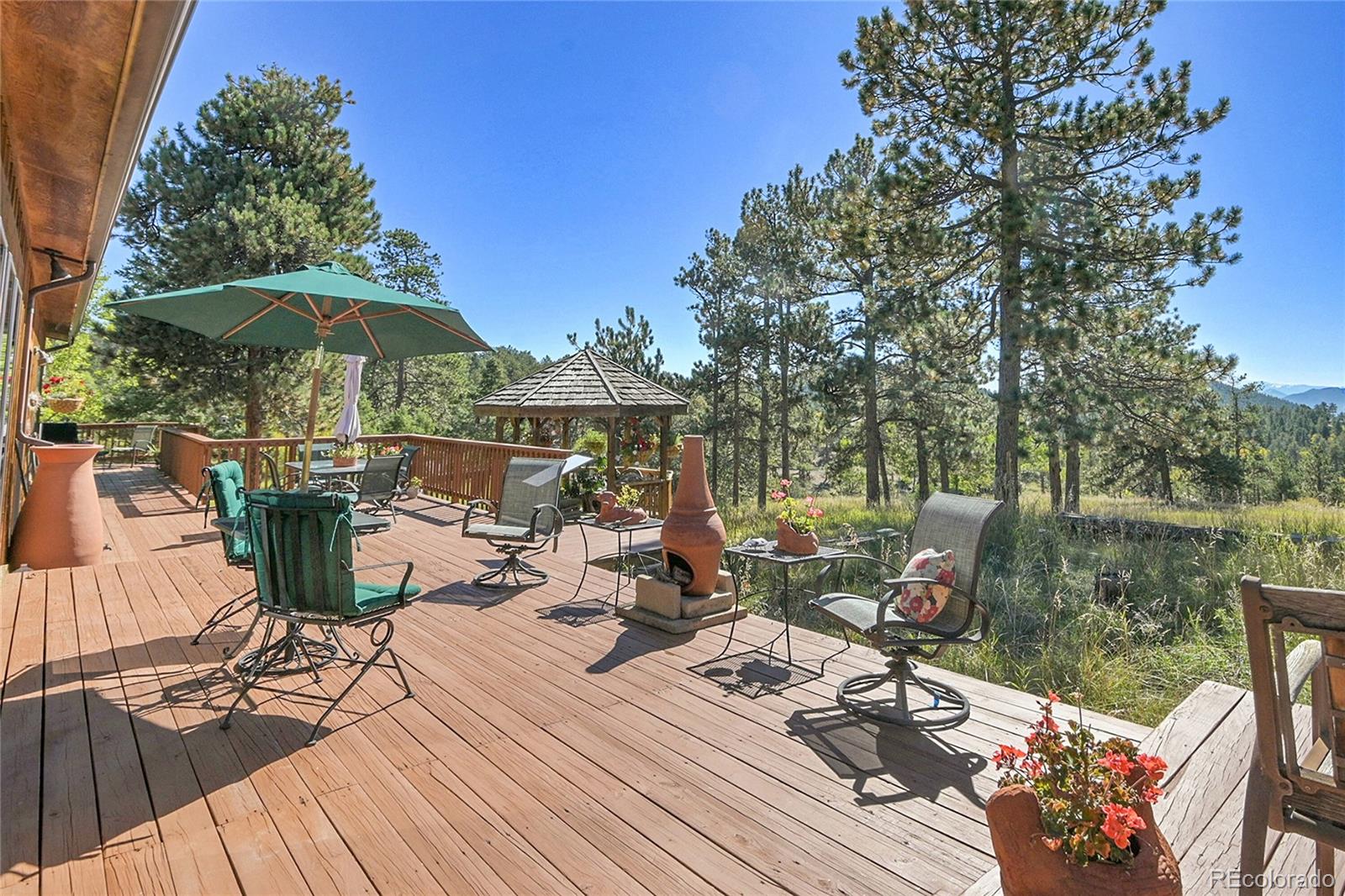 13082 South Wamblee Valley Road Conifer, CO 80433 - Photo 7 of 46 a view of a balcony with chairs and wooden floor