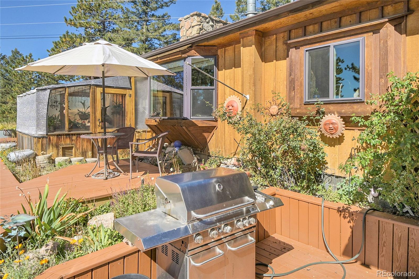 13082 South Wamblee Valley Road Conifer, CO 80433 - Photo 9 of 46 a patio with table and chairs
