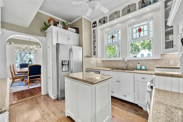 a white kitchen with a sink stove and refrigerator