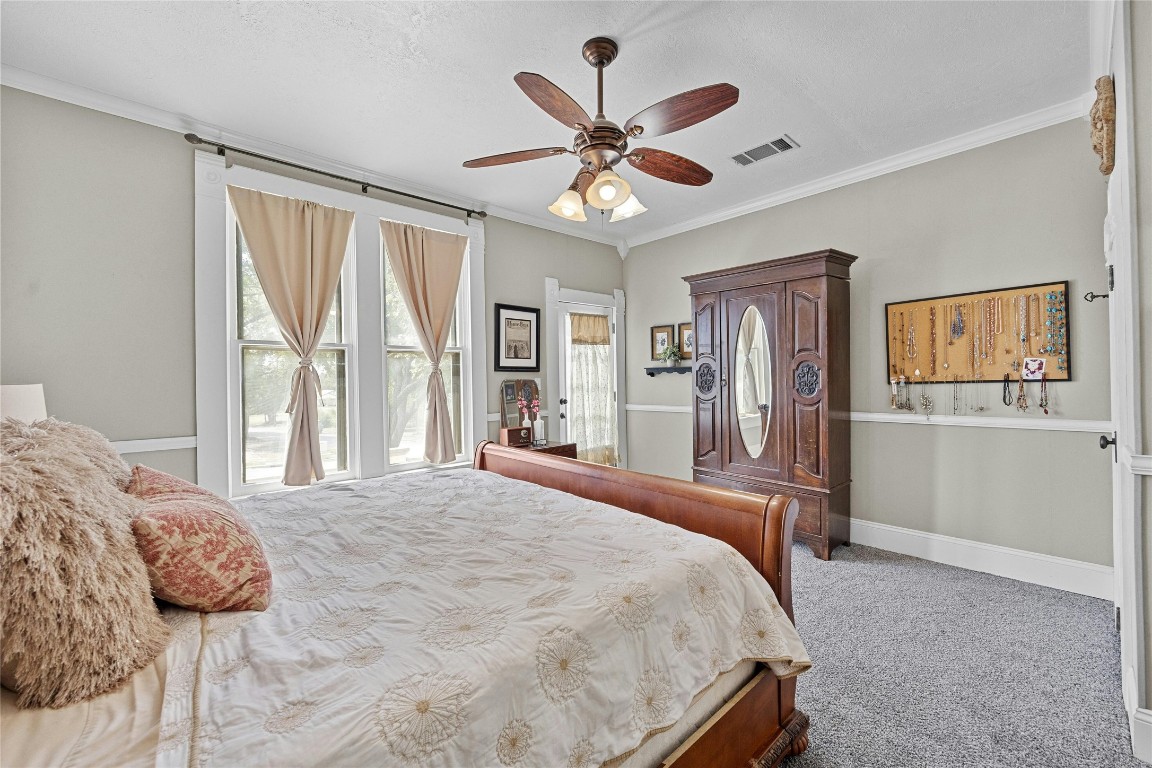 622 West 7th Street Taylor, TX 76574 - Photo 17 of 35 a bedroom with a large bed and a large window