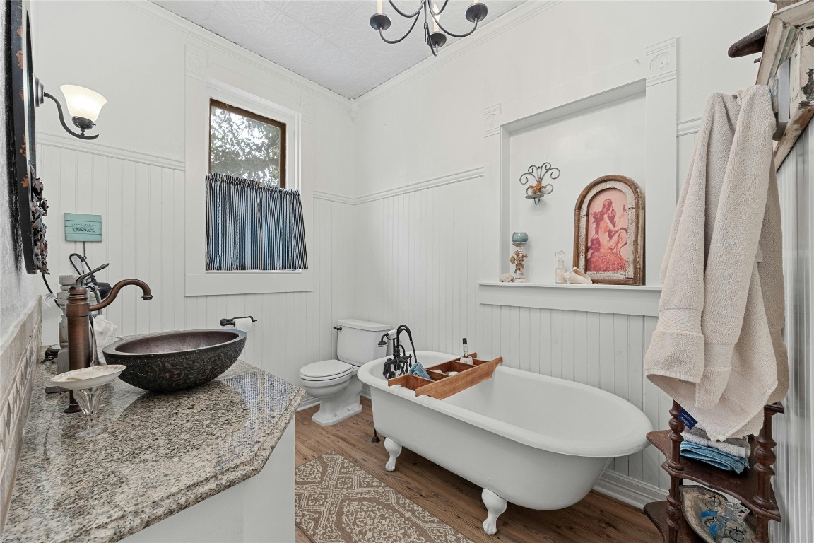 622 West 7th Street Taylor, TX 76574 - Photo 19 of 35 a bathroom with a granite countertop toilet sink and mirror