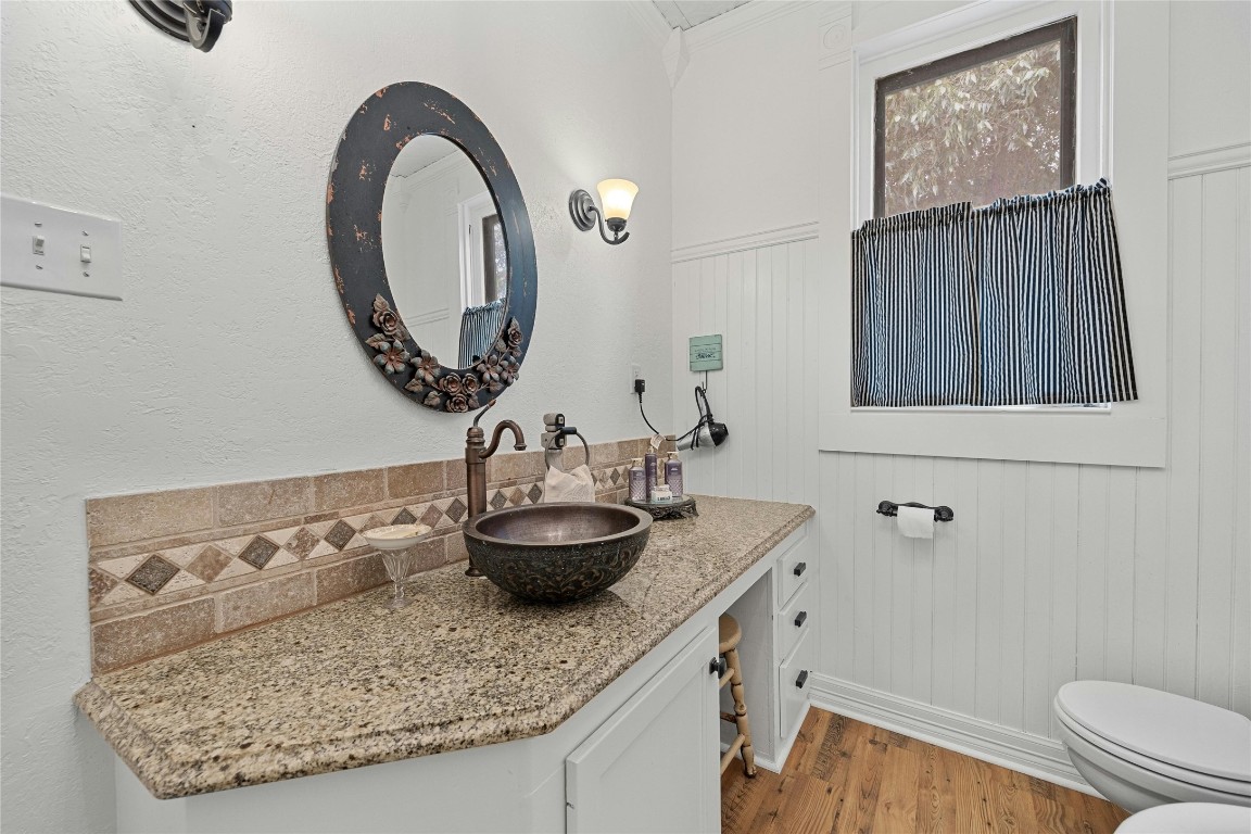 622 West 7th Street Taylor, TX 76574 - Photo 20 of 35 a bathroom with a granite countertop sink and a mirror